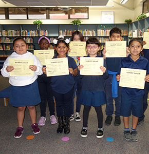 Group of students holding up certificates